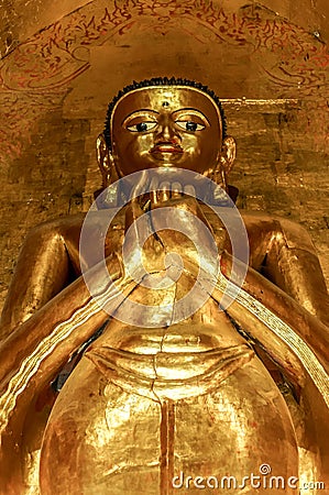 Tall standing golden Buddha showing Dharmachakra Mudra, Gesture Stock Photo