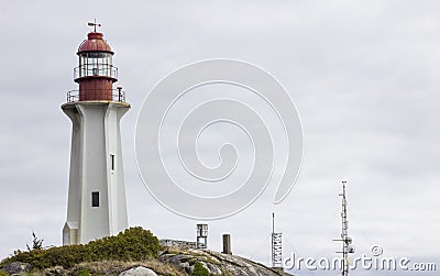 Tall stately lighthouse stands guard on Vancouver coastline. Stock Photo