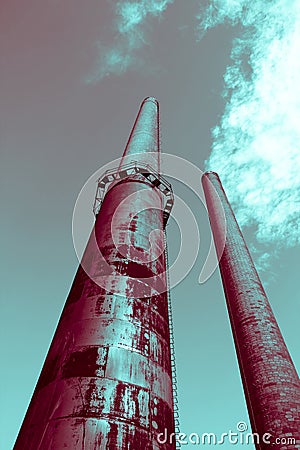 Tall surreal industrial smokestack factories produce smoke, concept of futuristic future and environmental pollution Stock Photo