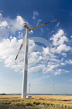 Tall Wind Turbine Overlooking Smaller Wind Turbines Stock Photo