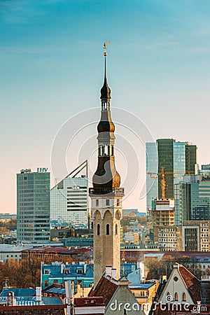 Tallinn, Estonia. View Of Tower Of Tallinn Town Hall On Background Of Modern Architecture. Oldest Town Hall In Baltic Editorial Stock Photo