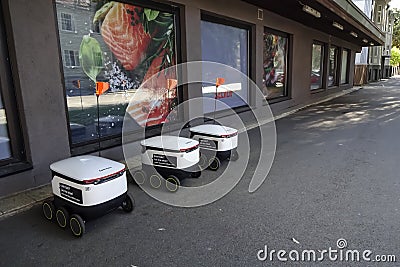 Tallinn, Estonia, Europe - September 26, 2021: Three modern automatic robot Starship for food delivery waiting on Editorial Stock Photo