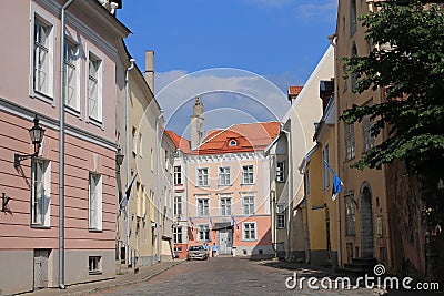 Street of Old Tallinn. Medieval houses, facades. On one house are Estonian and Finnish flags Editorial Stock Photo