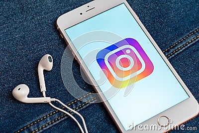 White phone with logo of social media Instagram on the screen. Social media icon. Editorial Stock Photo