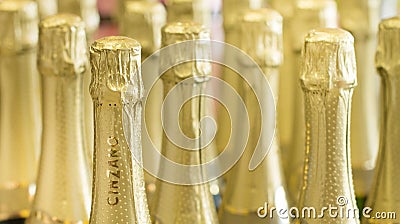 Tallinn Estonia - November 5th 2016: Cinzano gold champagne bottles necks and top caps at standing the light background Editorial Stock Photo