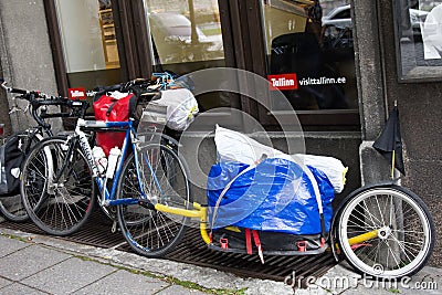 bike is tied on street with original Bicycle trailer. Bicycle bag Editorial Stock Photo