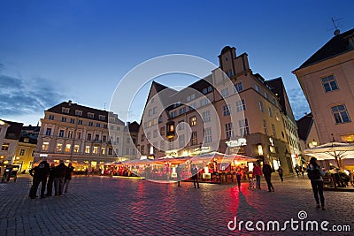 TALLINN, ESTONIA- SEPTEMBER 5, 2015 A crowd of tourists visit evening Town hall square in the Old city on September 5, 2015 in Tal Editorial Stock Photo