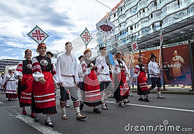 Estonian people in traditional clothing walking the streets of Tallinn Editorial Stock Photo