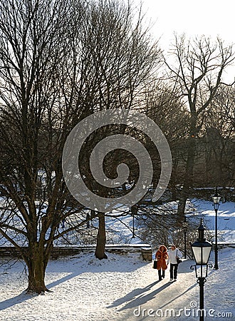 Two women walk in a park near the city wall in Tallinn, Estonia Editorial Stock Photo