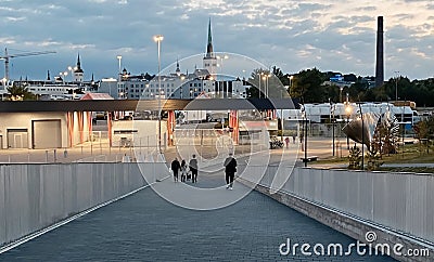 Tallinn Old Town panorama people walking on port promenade on front city medieval church ruffle evening light blurred view from ha Editorial Stock Photo