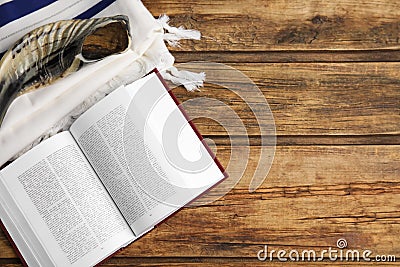 Tallit, shofar and open Torah on table, flat lay with space for text. Rosh Hashanah celebration Stock Photo