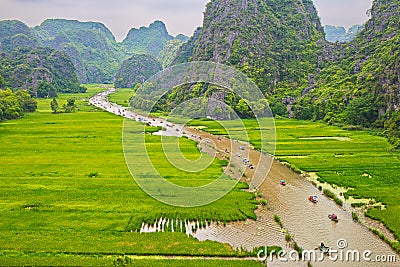 Tourists travelled along a stream inside ripen rice fields. Editorial Stock Photo