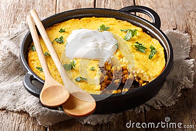 Tamale pie casserole served with sour cream close-up in a pan. horizontal Stock Photo