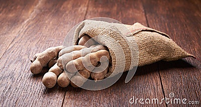 Tamarind in bag on a wooden table Stock Photo