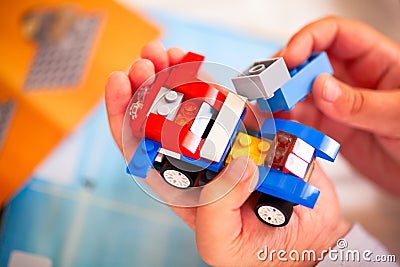 Child building Lego car. Editorial Stock Photo