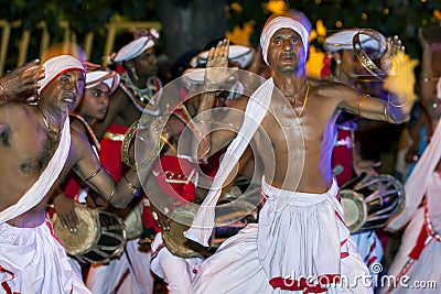 Tamerine Players perform to the beat of Getabera drummers along the streets of Kandy in Sri Lanka during the Esala Perahara. Editorial Stock Photo