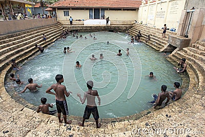 Tamil bathers enjoy a swim in Keerimalai Sacred Bath in the northern Sri Lankan region of Jaffna. Editorial Stock Photo