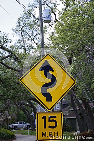 15 Miles Per Hour & squiggly street sign with electric pole in background Editorial Stock Photo