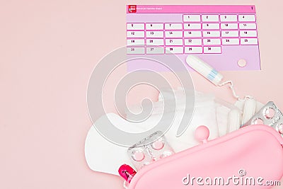 Tampon, feminine, sanitary pads for critical days, feminine calendar, pain pills during menstruation on a pink background. Stock Photo