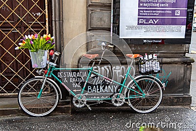Tandem bicycle advertising Na Balkany Restaurant & Bar at Warsaw`s Old Town Stare Miasto Editorial Stock Photo