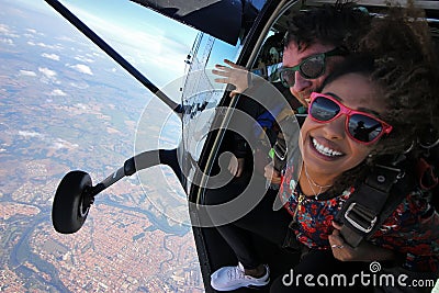 Tandem parachute jump. Beautiful Brazilian woman Stock Photo