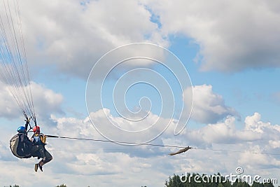 Tandem Paragliding takeoff from the field. Blue sky with clouds Editorial Stock Photo