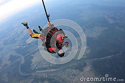 Skydiving. Tandem jump. Man and young woman are falling in the sky together. Stock Photo