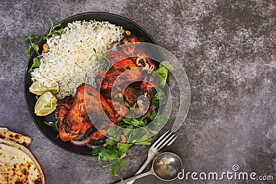 Tandoori spiced chicken wings served with pilau rice Stock Photo
