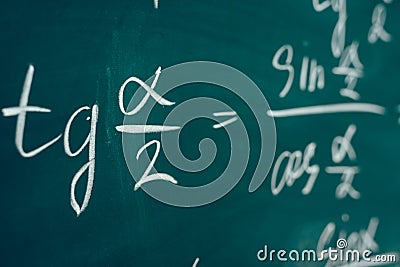 Tangent alpha sine cosine. Trigonometric formula written on the board. Stock Photo