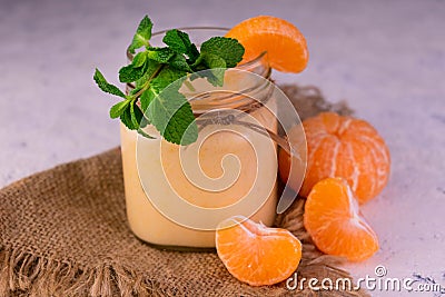 Tangerine banana smoothie in a jar on a white background. Stock Photo