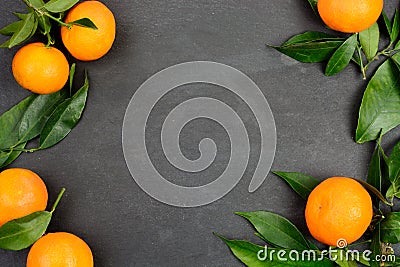 Tangerine fruits on dark table Stock Photo