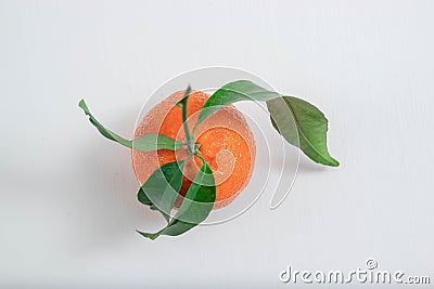 Tangerine with mandarin leaves with drops isolated on a white background. Stock Photo