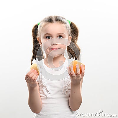 Tangerines and chips, healthy and harmful, a girl with a tangerine and chips in her hands on a white background. Stock Photo