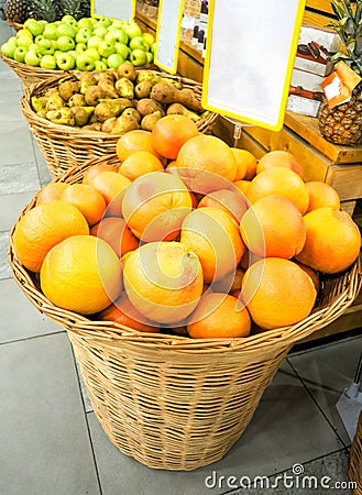 Tangerines, grapefruits and oranges in basket Stock Photo