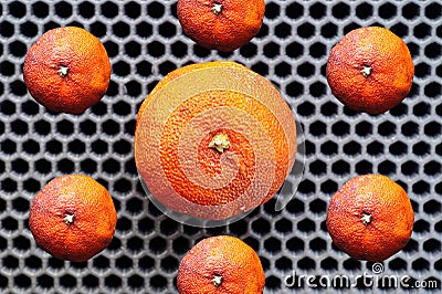 Tangerines ugly on the background of a hexagonal pattern Stock Photo