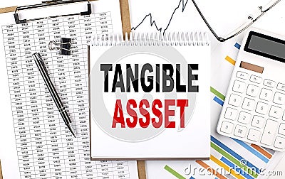 TANGIBLE ASSETS text on notebook with chart, calculator and pen Stock Photo