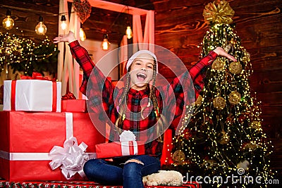 Tangible list things believe would make life better. Kid with gift christmas tree. Childhood gift we always wanted Stock Photo