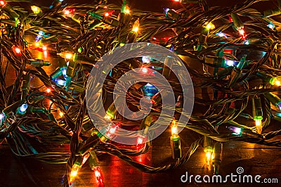 Tangled Christmas lights on a table Stock Photo