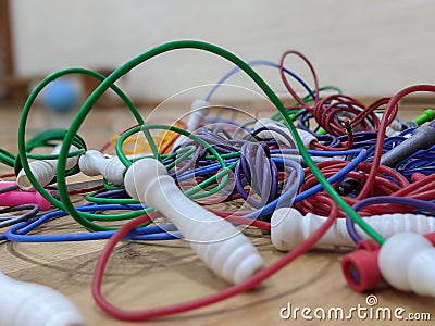 A tangled pile of brightly coloured skipping ropes Stock Photo