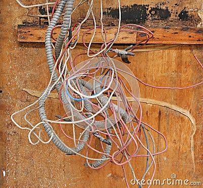 Tangled Wires against wood board Stock Photo