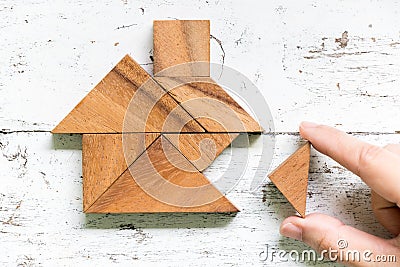 Tangram wait to fulfill home shape on old white wood background conept for build dream home, happy life, house or mortgage Stock Photo