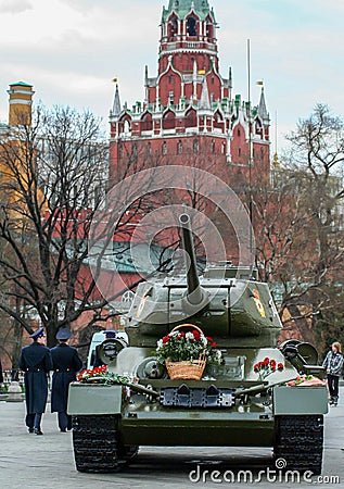 Tank covered by flowers on background of Moscow Kremlin. Unusual decorative elements on the Moscow street. Editorial Stock Photo
