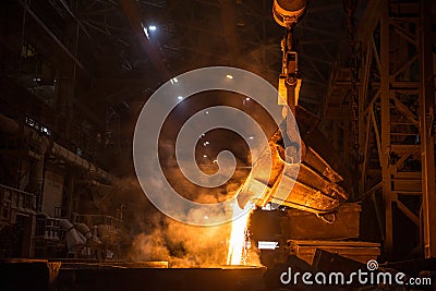 Tank pours liquid metal in the molds at the steel mill Stock Photo