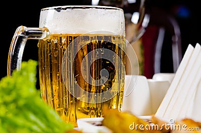 Tankard of chilled beer with a frothy head Stock Photo