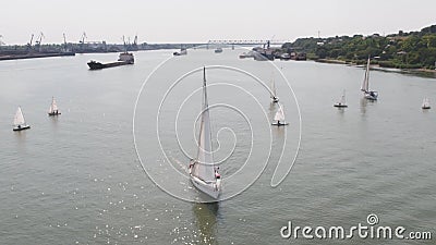 Tanker ship and sailboat on river. Aerial view. Sailboats and a tanker Stock Photo