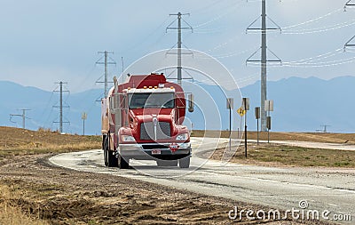 Tanker or Tank Truck on a road with Rocky Mountains silhouette on the background Editorial Stock Photo