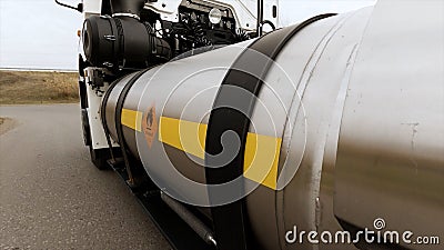 Tanker truck moves on the highway, close up of metal fuel tank with a fire hazard sign. Scene. Process of oil Stock Photo