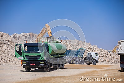 Tankers and trailer trucks in quarry mining area in desert Editorial Stock Photo