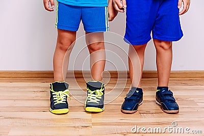 Tanned children`s feet in sports sneakers Stock Photo