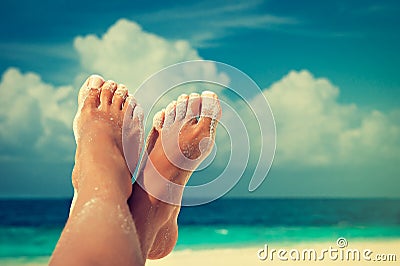 Tanned feet with pedicure Stock Photo